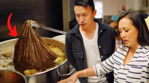 Wilson K Lee by a pot of broth in the kitchen at Banh Mi Tres Bon