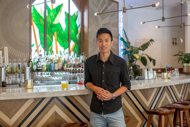 Wilson K Lee standing at a restaurant bar